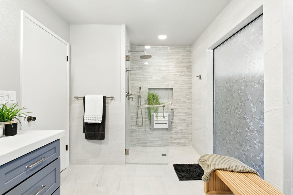 Universal bathroom design with walk-in shower, frosted privacy windows, and ample space