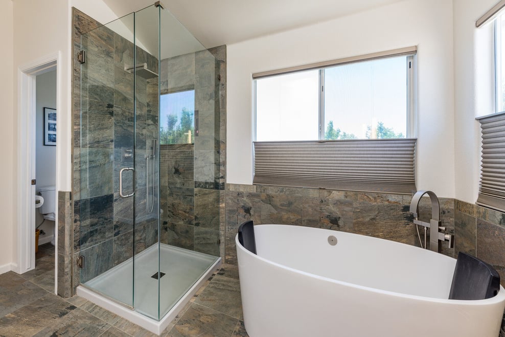 Freestanding tub and walk-in shower next to window in Fresno bathroom remodel by Imagine Remodeling