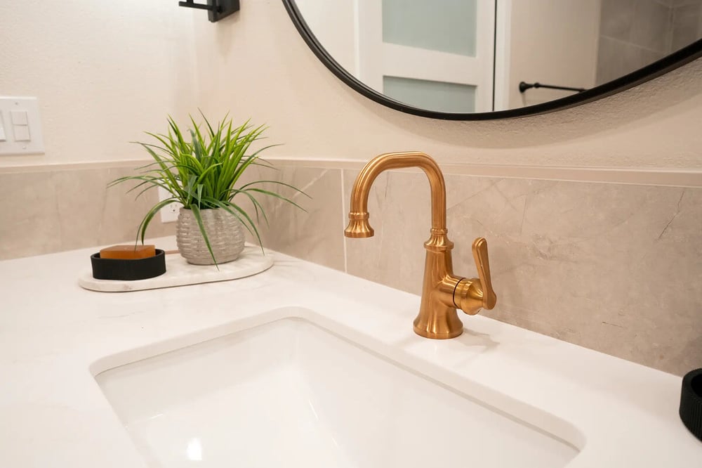 Under mount sink with brass faucet in Fresno, CA bathroom by Imagine Remodeling