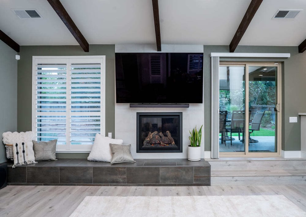 Fireplace beneath mounted TV in Fresno first floor remodel by Imagine Remodeling