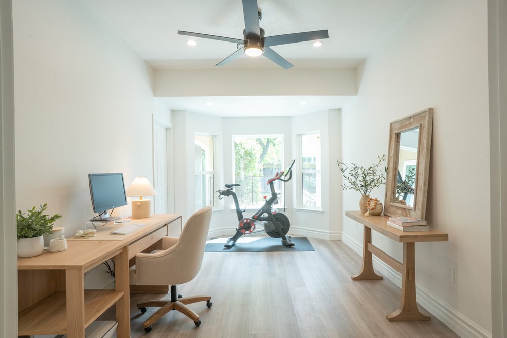 Home office remodel with bike near window in Fresno, CA home remodel by Imagine Remodeling