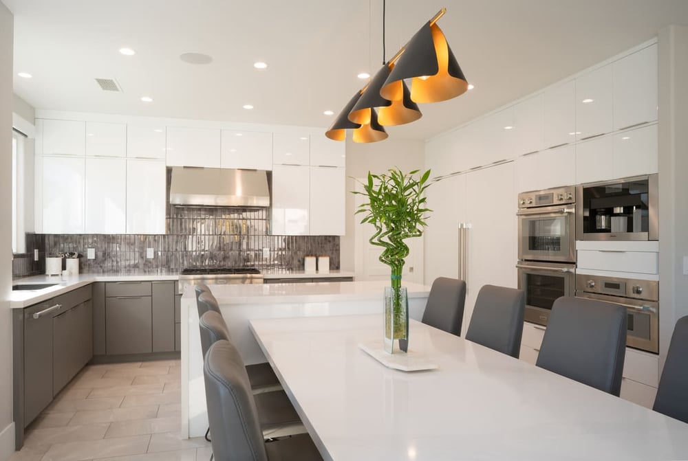 White kitchen island with pendant lighting in Fresno remodel by Imagine Remodeling