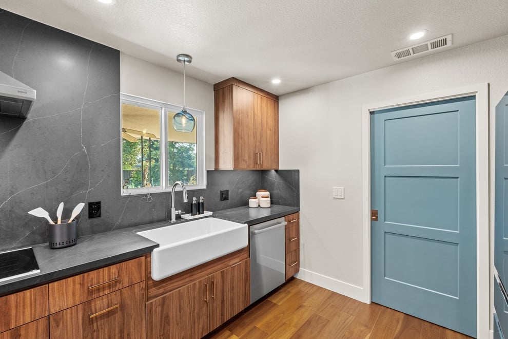 Contemporary Fresno kitchen with farmhouse sink, wood cabinets, and blue door