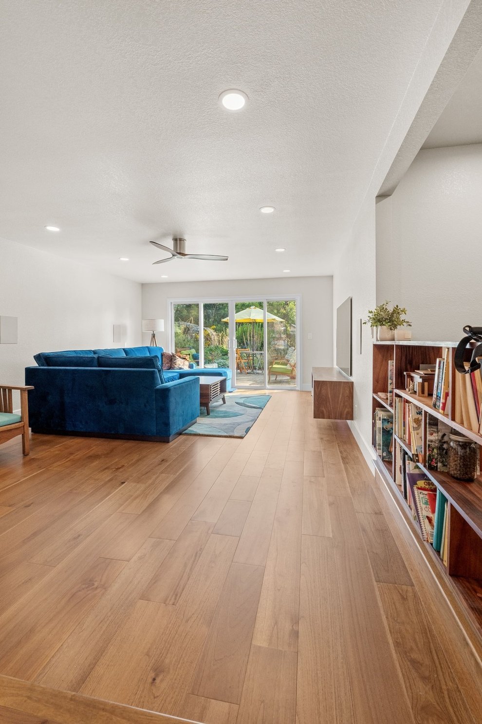 Open Fresno living room with wood floors and view of patio through sliding glass doors