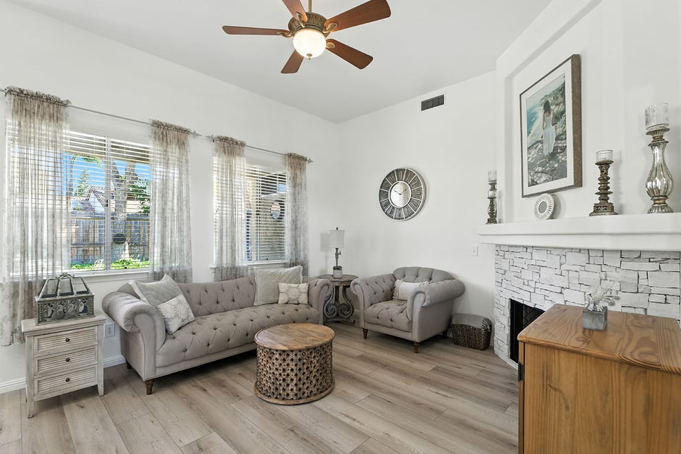 Elegant Fresno living room by Imagine Remodeling with tufted seating and large windows for natural light