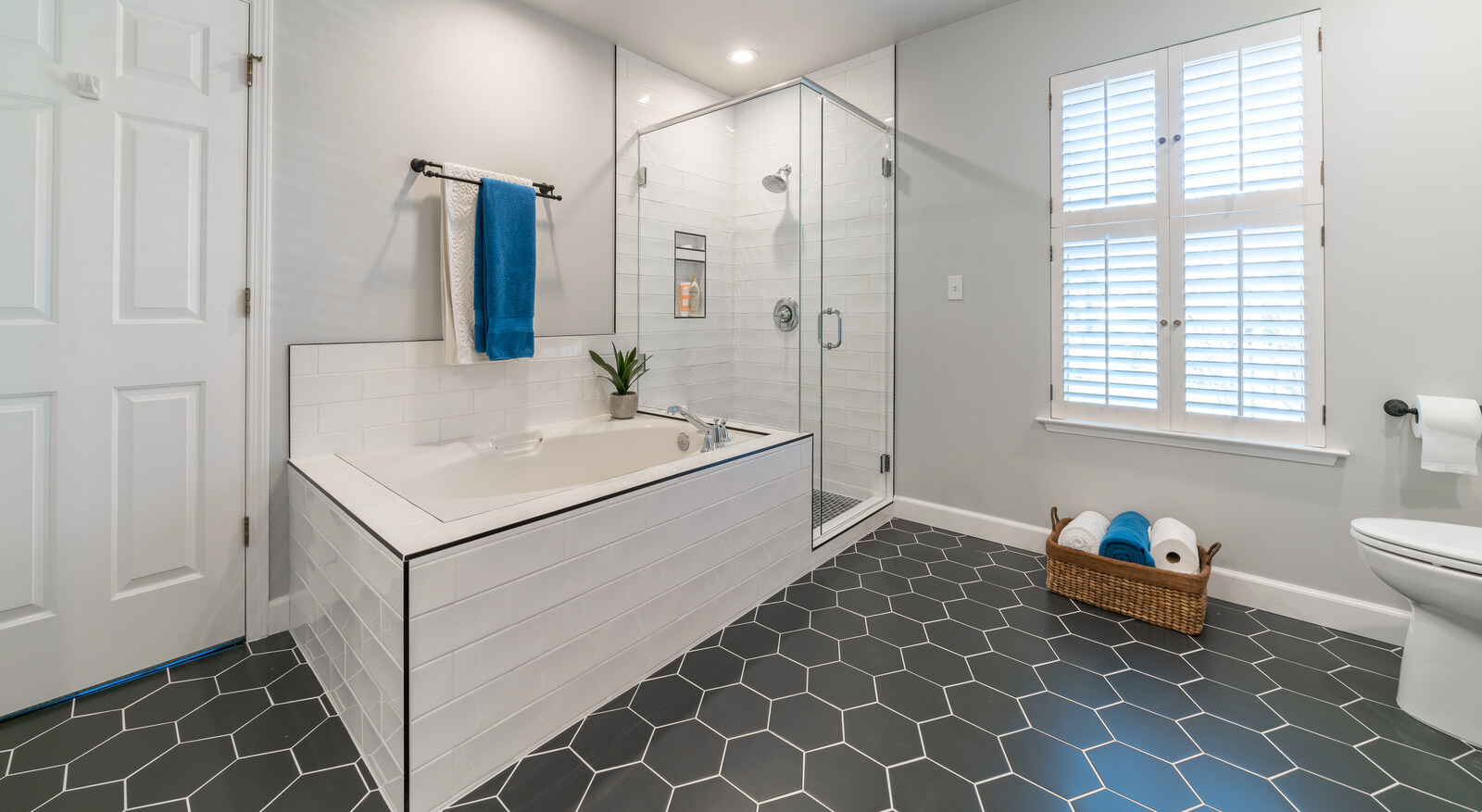 hexogonal tile floor in bathroom remodel in fresno with standing shower and spa bath tub (1)