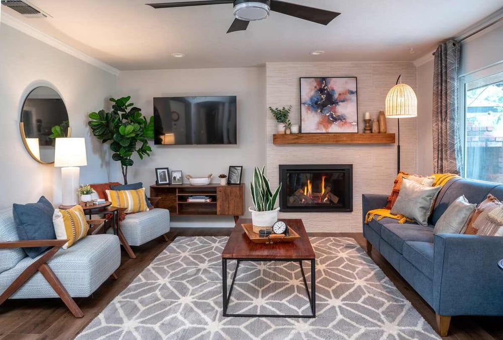 living room interior designed with rug couch fireplace coffee table two lounge chairs and floating tv in fresno remodel (1)