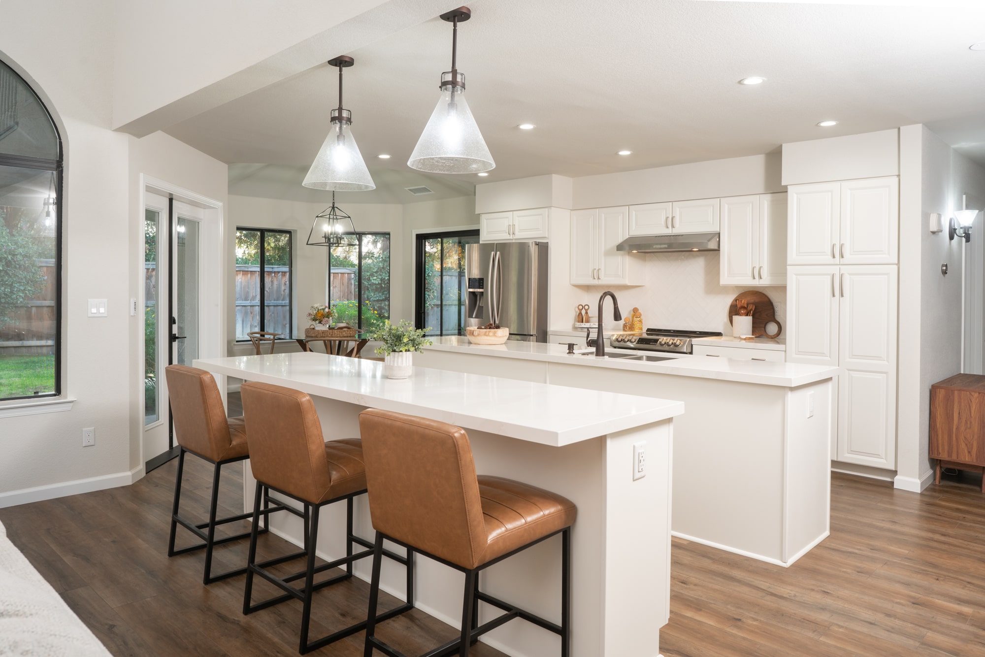 modern white kitchen with two islands in fresno california costs