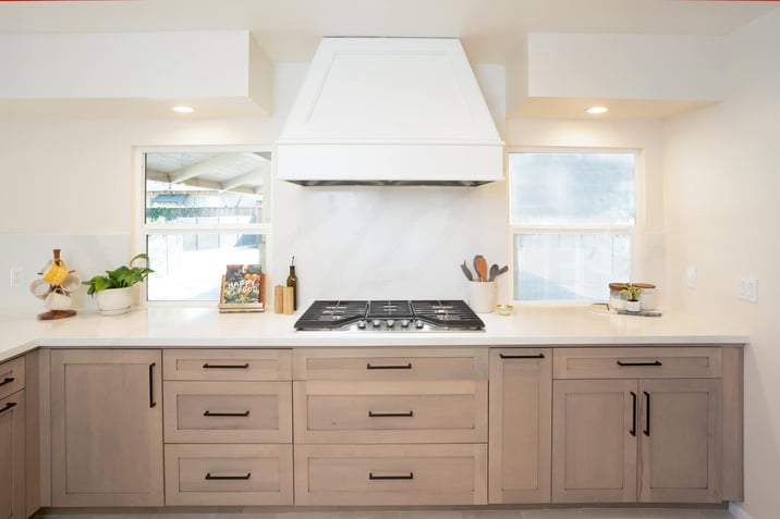 slab wall backsplash with range hood over chefs stove kitchen remodel