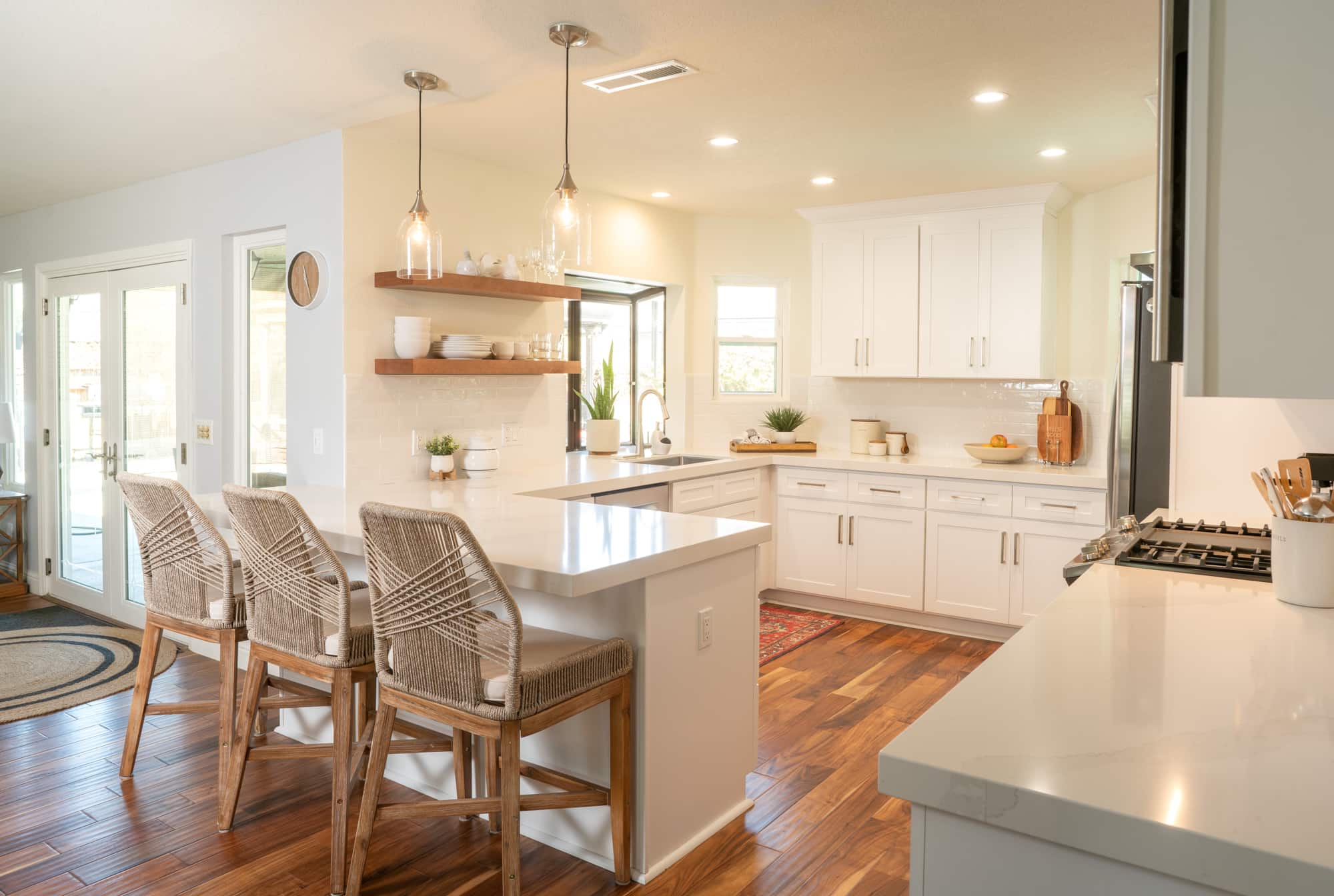 warm kitchen remodel in fresno california and chairs at kitchen ledge